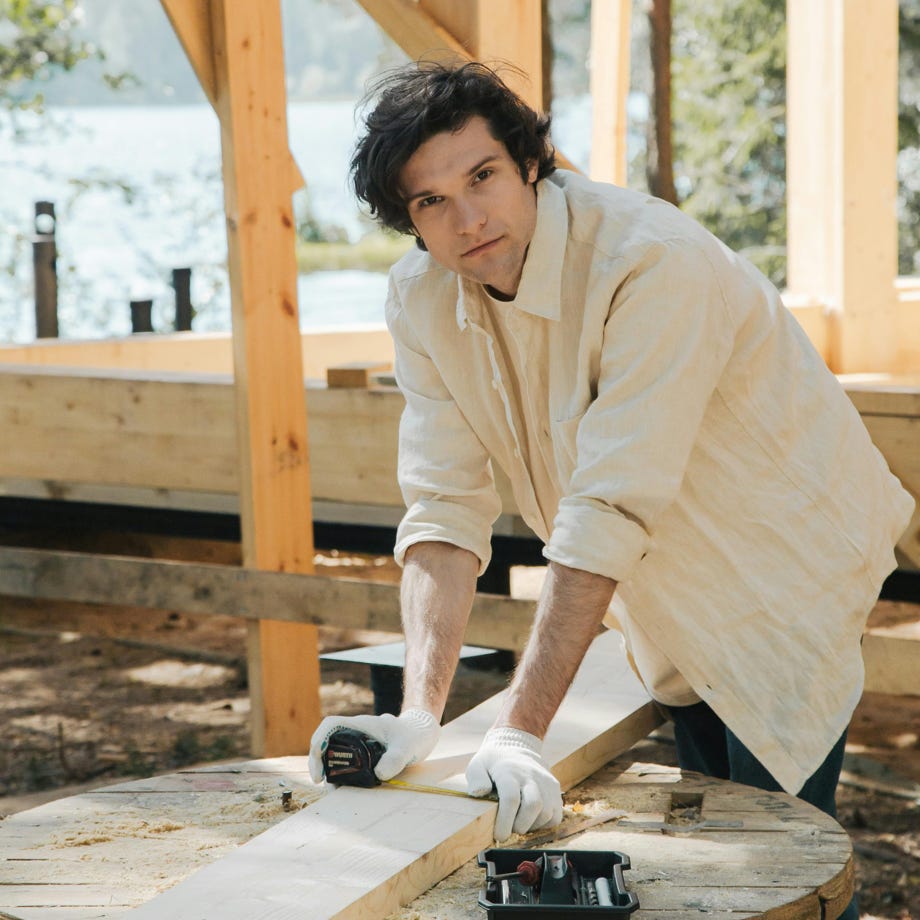 Man Measuring a Wood