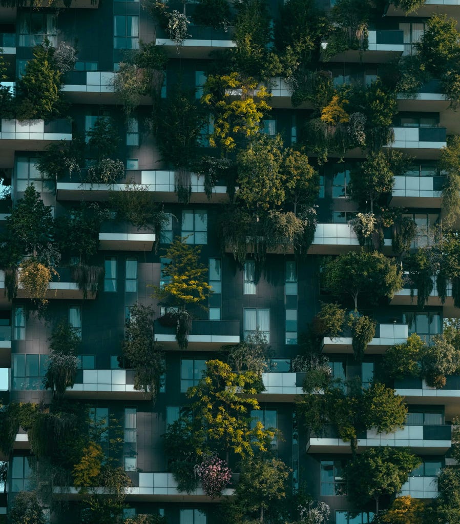 Modern residential building facade decorated with green plants